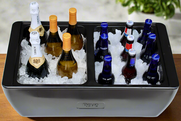 Black party cooler tray with champagne and beer bottles on ice in two sections
