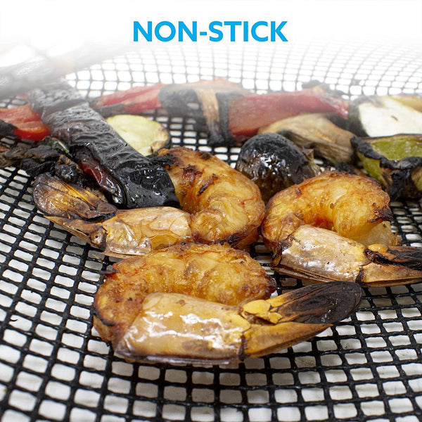Grilled seafood pieces on a wire grill grate