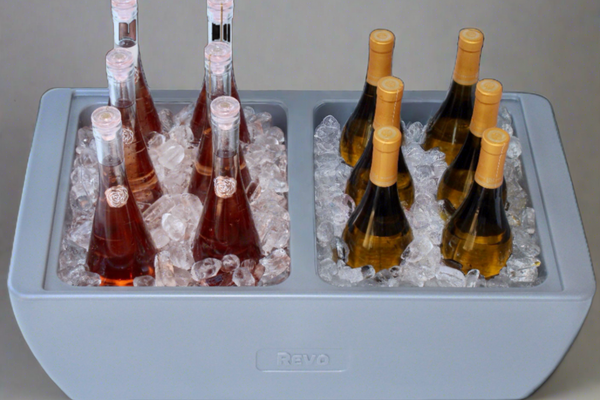 Metallic gray party cooler insert with ice, wine bottles, and champagne bottles