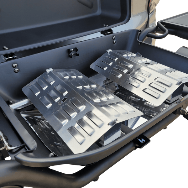 Metal flame tamer heat deflectors inside a grill grate, multiple slotted panels