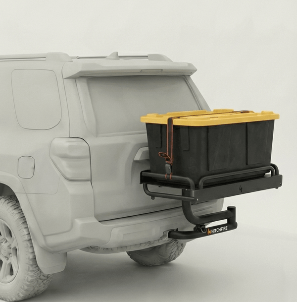 Hitch cargo platform with black tray and yellow-lidded storage bin mounted on swing arm