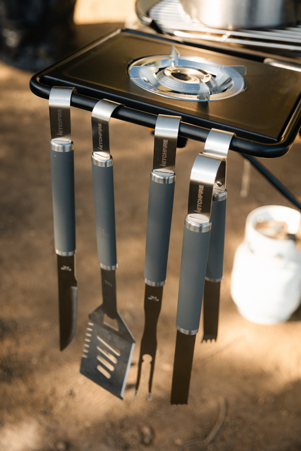 Grilling tools hanging on side burner table