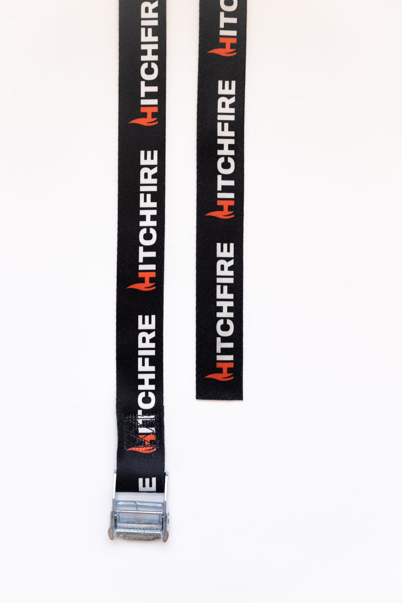 Cam straps with HITCHFIRE printed webbing and metal buckle end, laid out