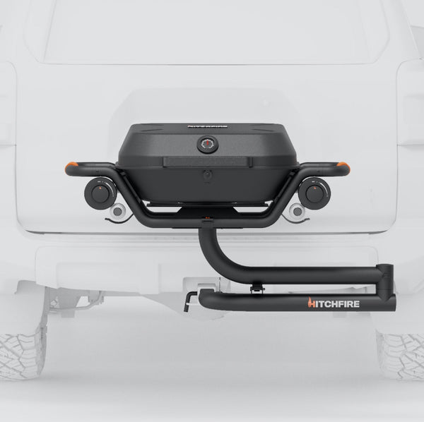 Hitch-mounted propane grill with black lid and two side control knobs