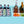 Load image into Gallery viewer, Blue party cooler tub with ice, cans, and bottles, plus fruit and cucumber
