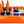 Load image into Gallery viewer, Orange Burst party cooler bin with champagne bottles and snack compartments, REV0 logo

