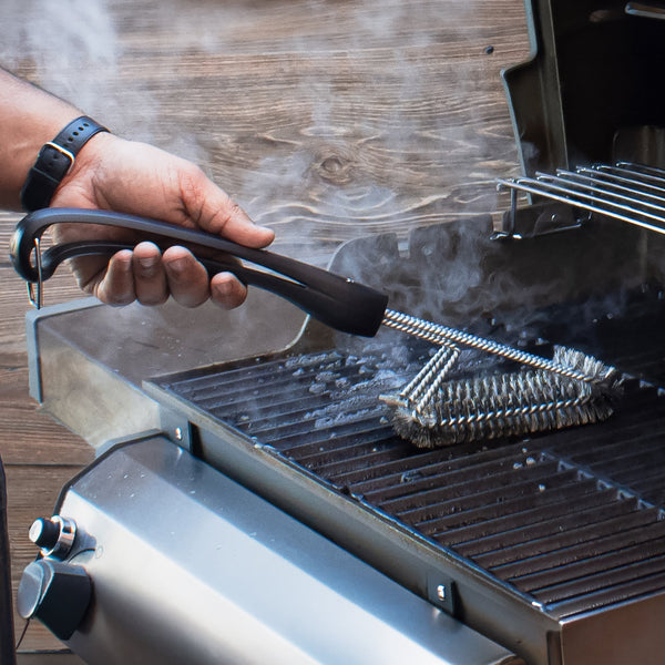 Grill brush with black handle and angled metal bristle head for 360 cleaning