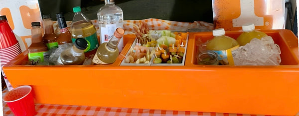 Orange Burst REVO Party Barge Cooler™ with open serving compartments