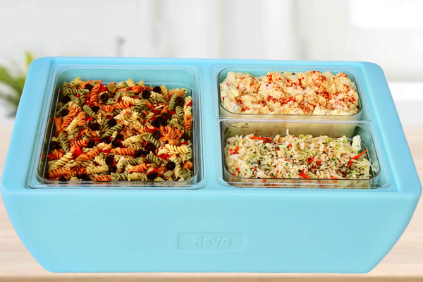 Light blue heated food chafer with two inset pans of pasta salad and rotini