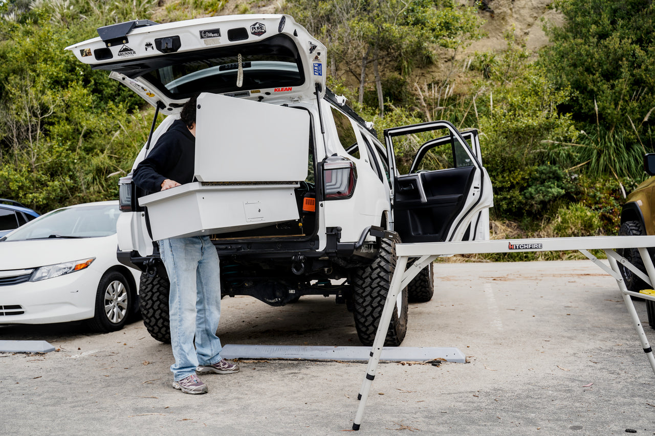 Camp Kitchen box open on vehicle rear with folding side table extended