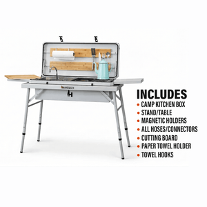 Camp kitchen grill with open lid, teal kettle, sink, and utensil storage
