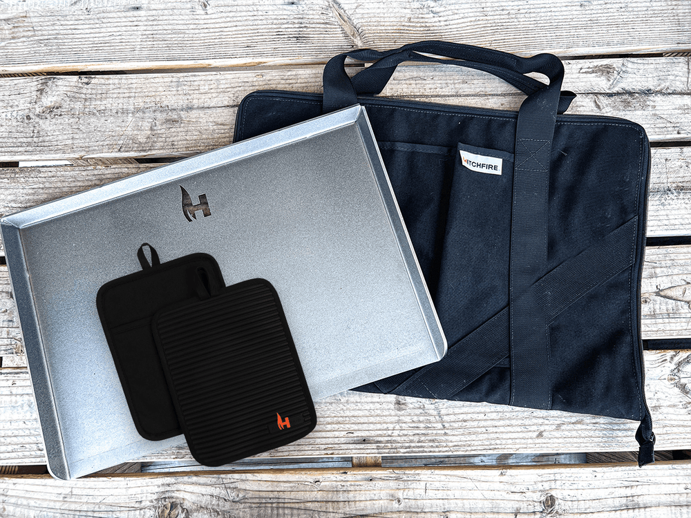 Cast iron griddle kit with metal tray, black gloves, and dark carry bag