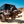 Load image into Gallery viewer, Jeep Wrangler on a dirt road with a clear blue sky
