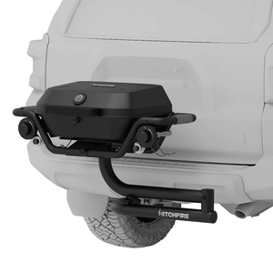 Hitch mounted propane grill with closed lid, side handle, and control knobs in dark finish.
