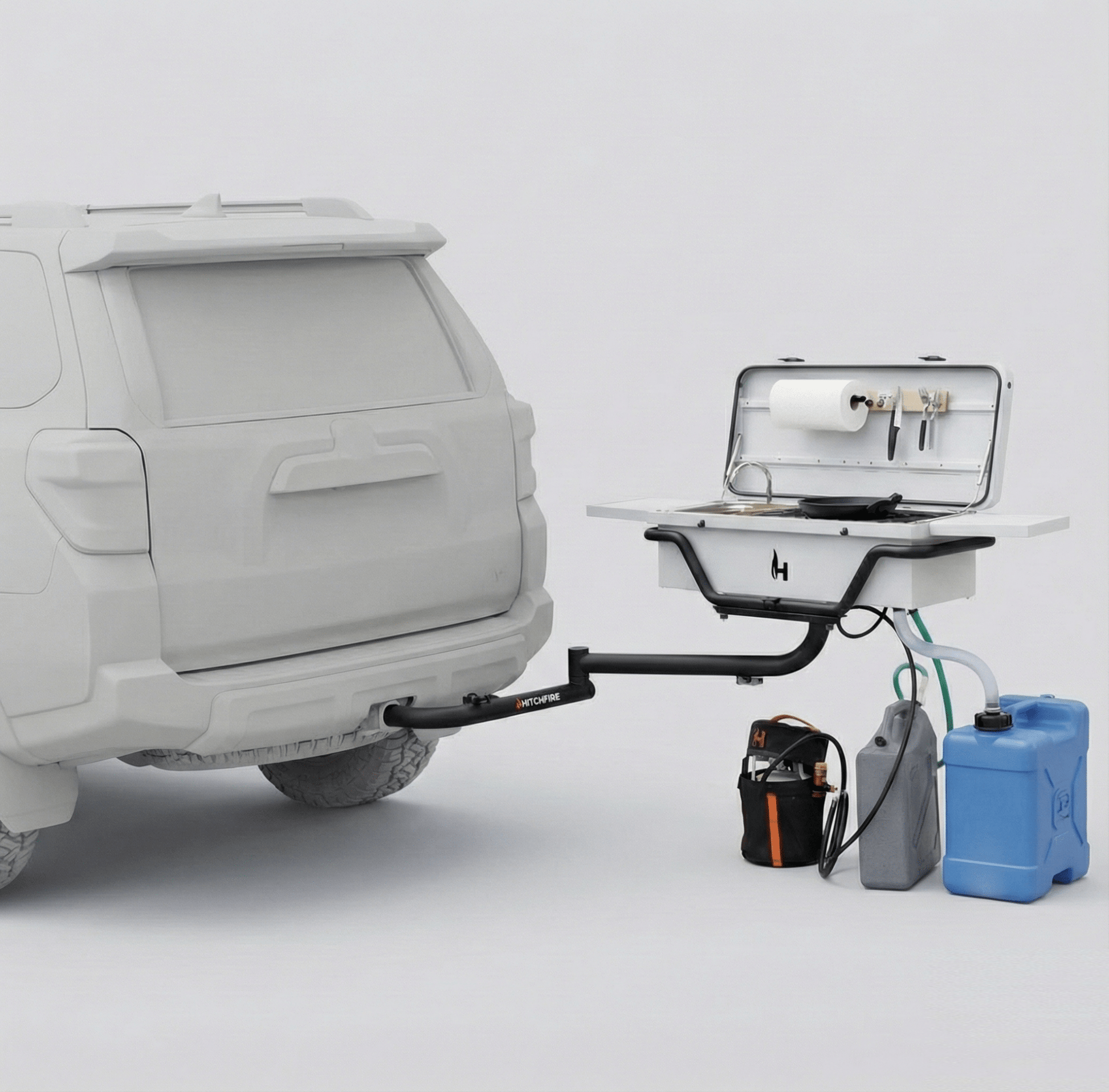 Vehicle-mounted outdoor kitchen on trailer with open sink, countertop, and power boxes