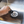 Load image into Gallery viewer, Hand installing sink drain stopper in metal drain opening
