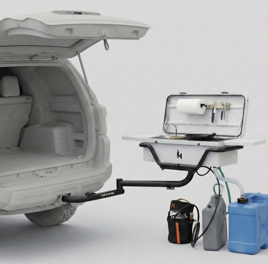 Hitchfire portable grill with open lid and side prep sink, plus cooking accessories