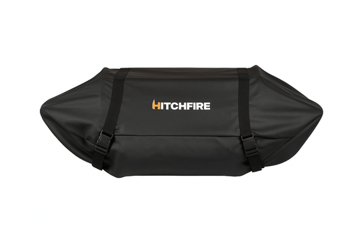 Black HitchFire grill cover with two front straps and center panel, laid flat