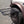 Load image into Gallery viewer, Close-up of large black aluminum camping table with wire mesh top on a spare tire mount
