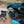 Load image into Gallery viewer, Large black aluminum camping table with wire mesh top and folding legs on outdoor ground
