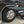 Load image into Gallery viewer, Large black aluminum camping table with wire mesh surface extended beside a vehicle
