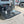 Load image into Gallery viewer, Black steel camping table with wire-mesh top and folding legs
