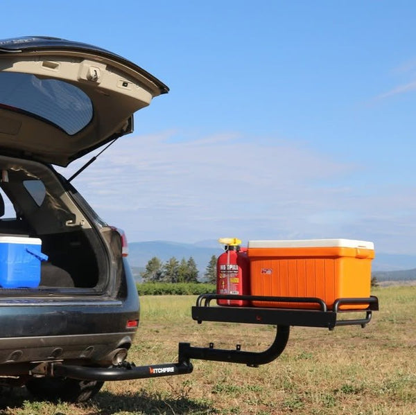 Vehicle cargo platform with orange storage box on rear swing arms