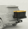 Hitch cargo platform with black tray and yellow-lidded storage bin mounted on swing arm