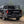 Load image into Gallery viewer, Rear cargo platform with mounted black storage cases on a pickup
