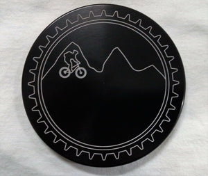 Round black trailer hitch cover with gear rim and mountain bike graphic