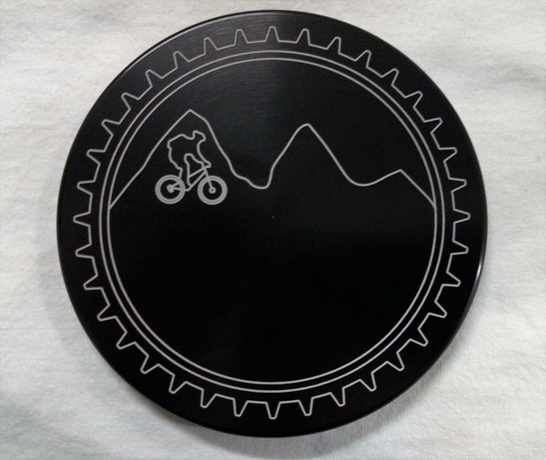 Round black trailer hitch cover with gear rim and mountain bike graphic