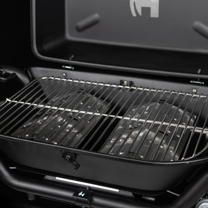 Open black propane grill showing stainless cooking grates and burner area