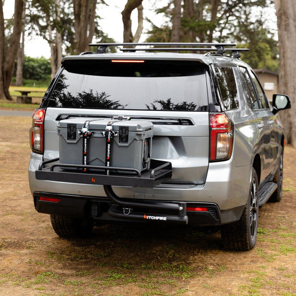 Silver SUV with black rear cargo platform and swing-out arm, open rear view