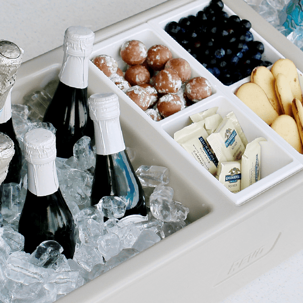 Greige mist party barge cooler with ice, champagne bottles, and snack bins.