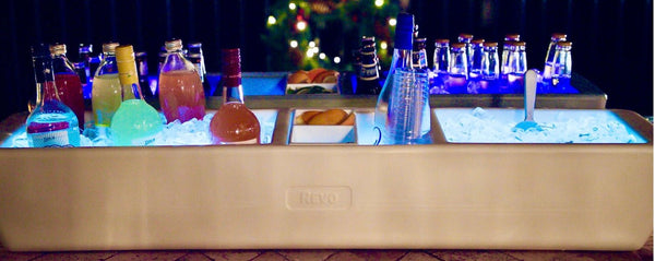 Greige mist party barge cooler with bottles on ice in the top channel.