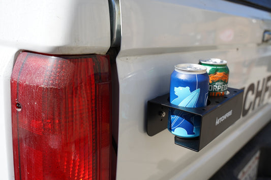 Magnetic spice rack and cupholder with black shelf and two bottle/can slots on truck