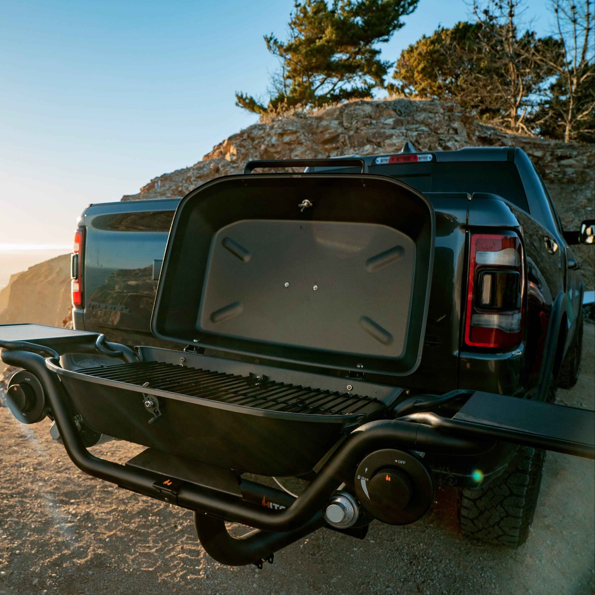 F-20 hitch-mounted propane grill with lid open, rear view of black grill