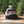 Load image into Gallery viewer, Black grill cover on vehicle rear with securing straps
