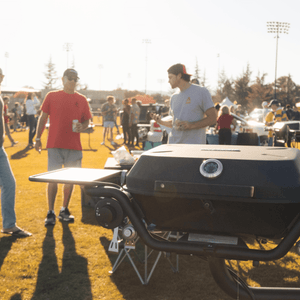 Black hitchfire propane grill with dual side shelves and round control knobs
