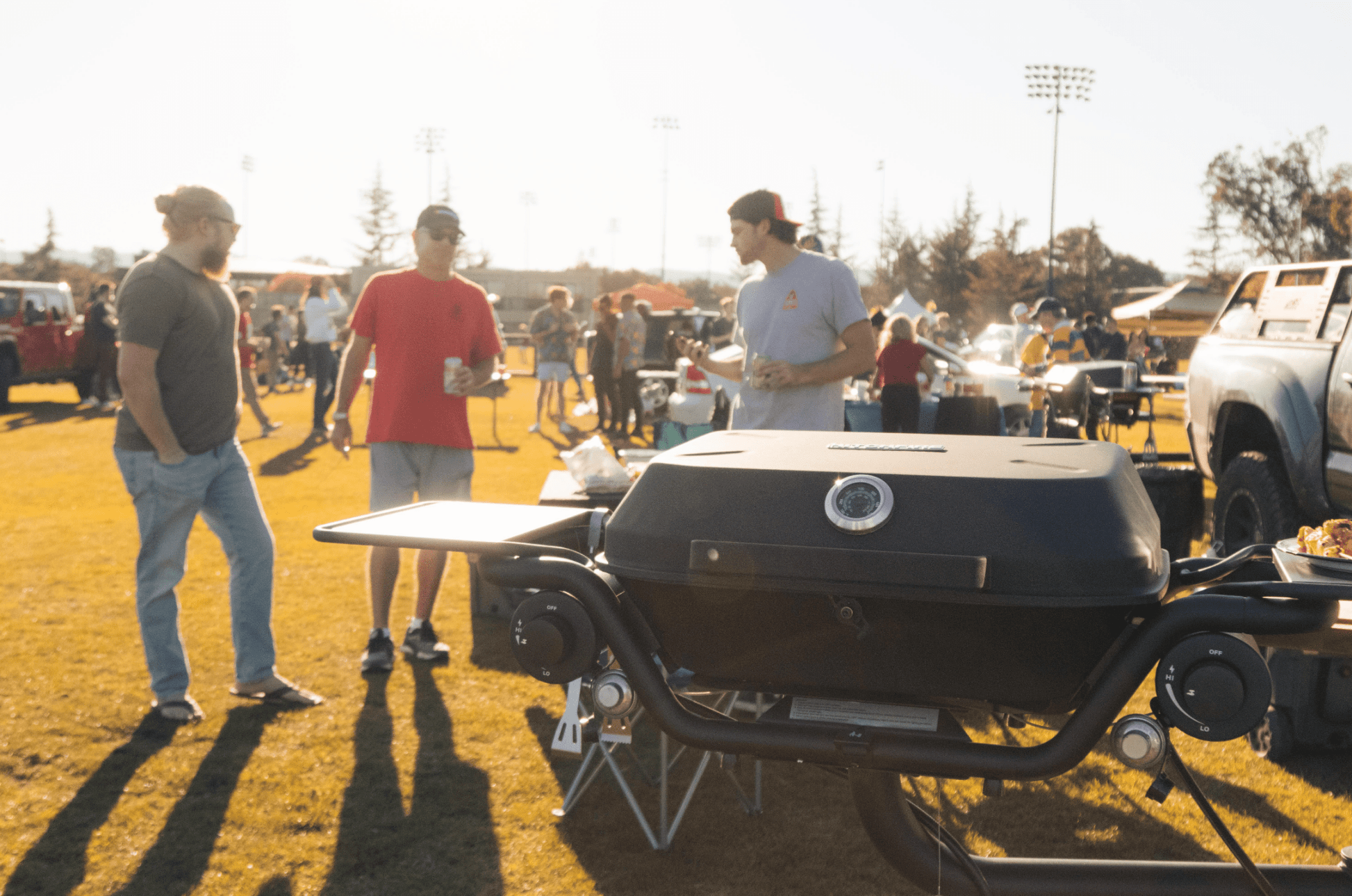 Black hitchfire propane grill with dual side shelves and round control knobs