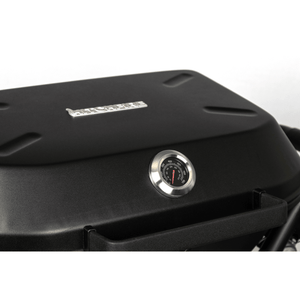 Black grill control panel with round temperature gauge on the lid